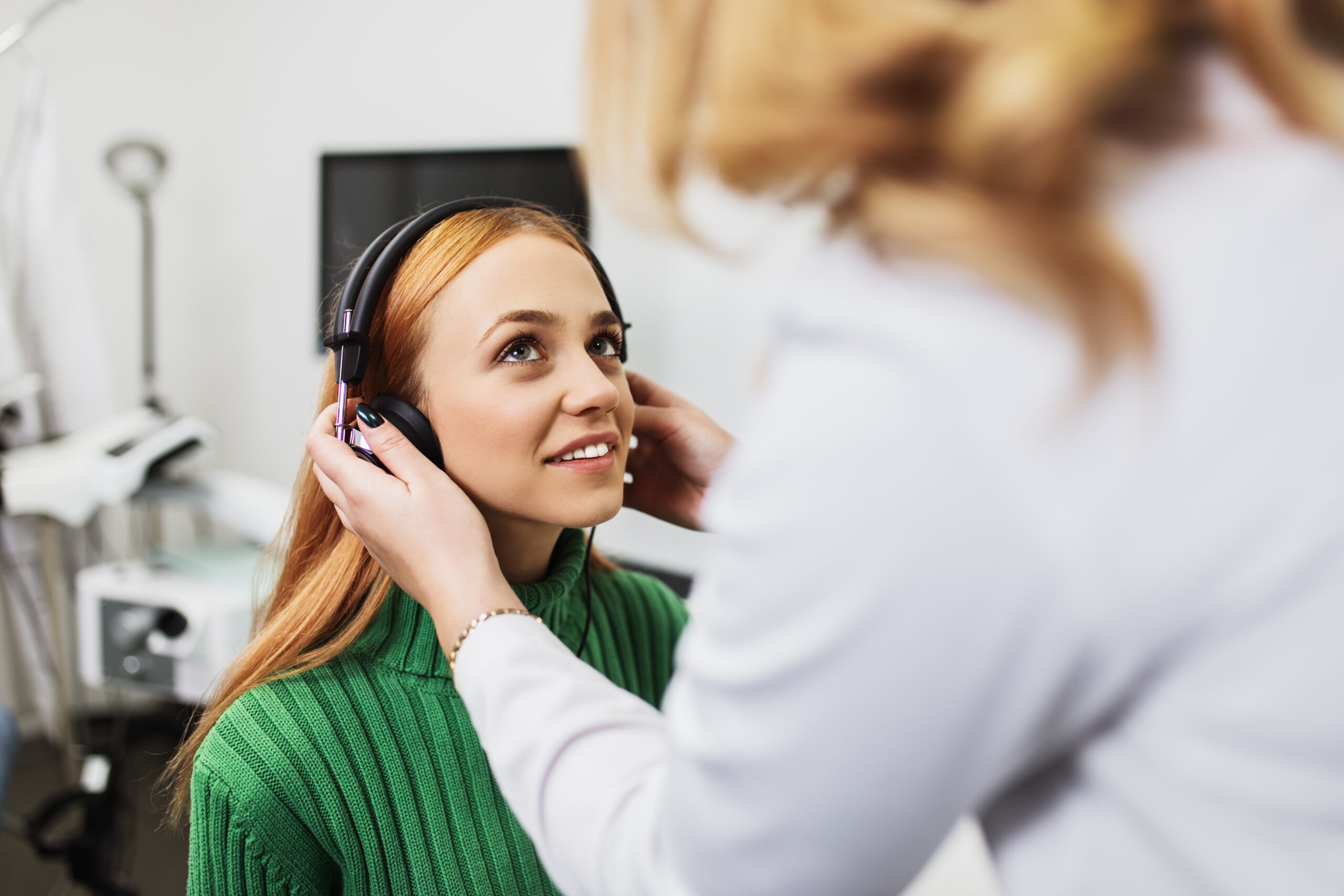 An audiologist conducting a hearing test for a Centennial resident at Modern Audiology."